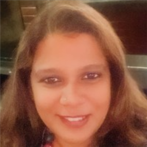 a person with long brown hair smiling for the camera